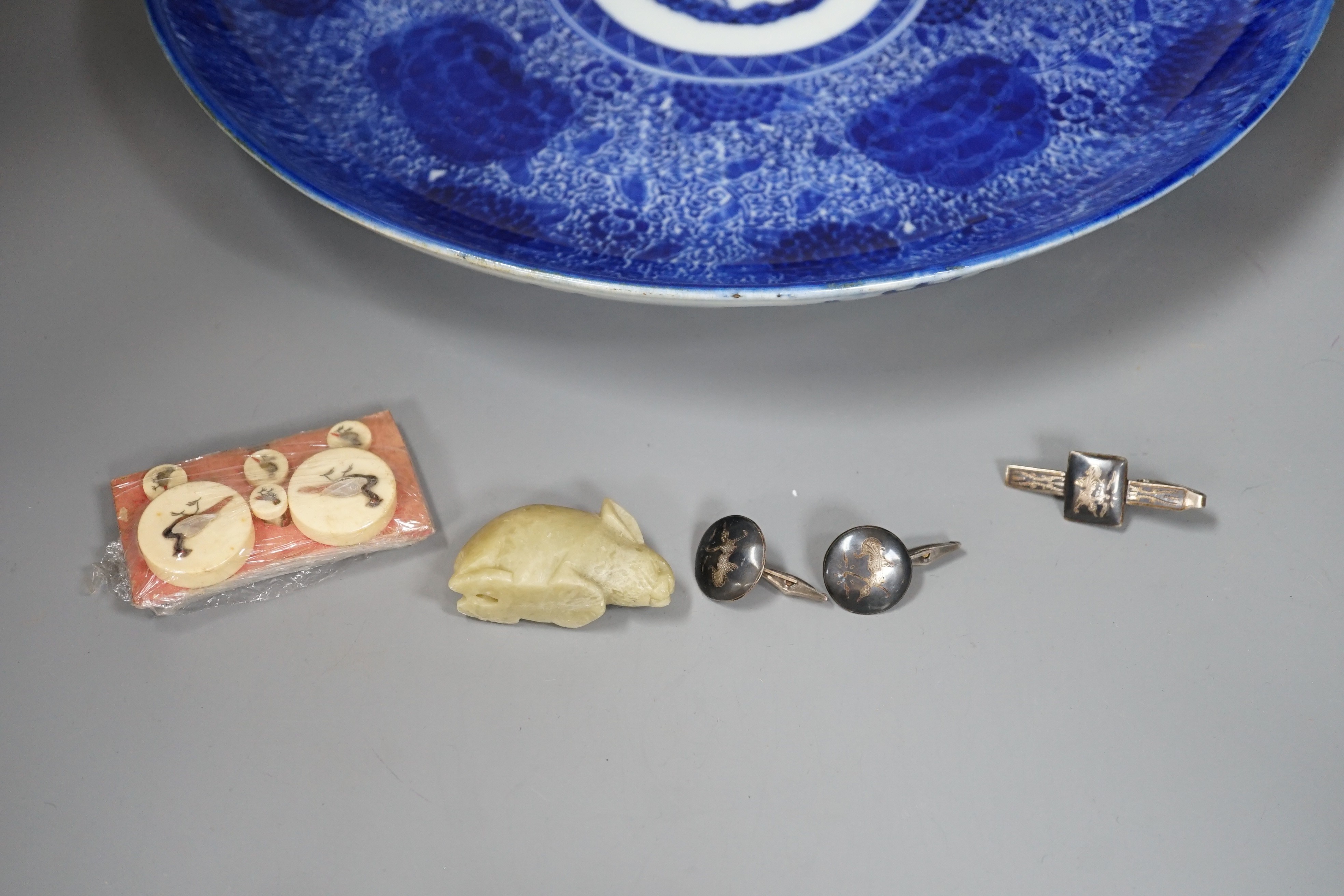 A Japanese Blue and White dish, a Set of Shibayama buttons, a soapstone rabbit, a Siamese cuff links and tie clip. Dish diameter 35cm